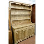 A Victorian style pine kitchen dresser, with a three shelf plate rack, above three drawers over thre