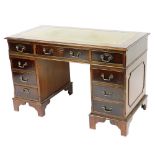 A mahogany twin pedestal desk, the gilt tooled green leather top over one long flanked by eight shor