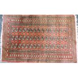 A Tekke Turkman red ground rug, with three central rows of fifteen guls, within repeating borders of