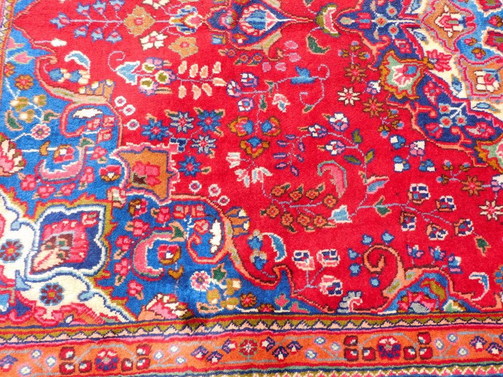 A Persian Tabraz carpet, on a red ground, 285cm x 185cm. - Image 2 of 3