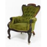 A Victorian rosewood shield back armchair, upholstered in green button back Draylon, the frame with