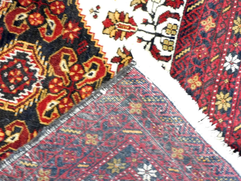 A Persian rug, possibly Quchan, with a central floral and foliate ground, within a red border of rep - Image 3 of 3