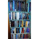 A large quantity of paperback and hardback books relating to UFOs, horror, some fantasy, magic, etc.