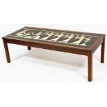 A mid century teak coffee table, possible Danish, with faux tile inset of stylised Egyptian pharaoh