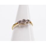 An 18ct gold and diamond three stone ring, illusion set, size P, 1.7g.