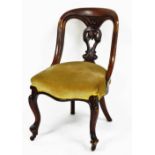 A Victorian mahogany spoon back chair, with overstuffed serpentine seat, raised on cabriole legs.