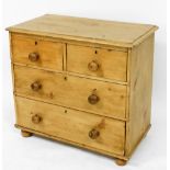 A Victorian pine chest, of two short over two long drawers, raised on bun feet, 74cm high, 84cm wide
