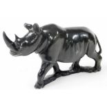 An African carved hardstone figure of a rhinoceros, 28cm wide.