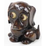 An early 20thC German carved wooden novelty dog clock, the revolving eyes forming the hour and minut