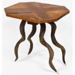 An octagonal parquetry topped table, raised on four antelope horns, 55cm high, 53cm wide,