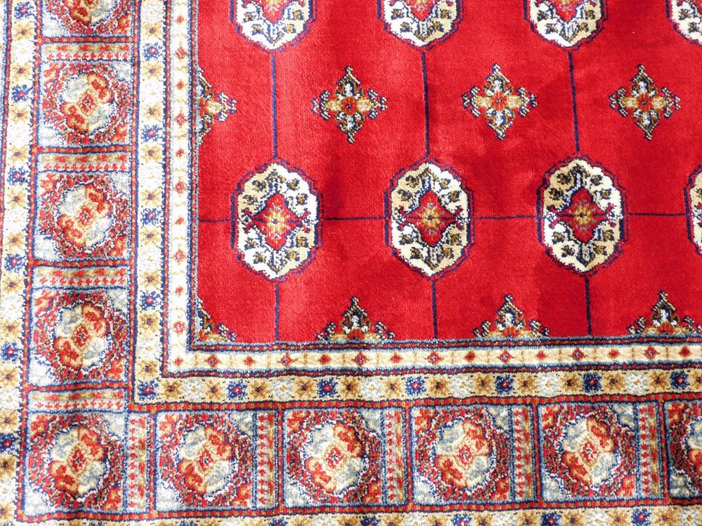 A Bokara Cashmere rug, on red ground with all over design, 170cm x 120cm. - Image 2 of 3