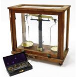 A set of Philip Harris Limited scientific laboratory scales, to weigh up to 250g, cased, 59.5cm wide