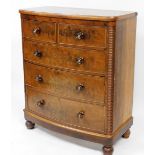 A Victorian flame mahogany bow fronted chest, of two short over three long drawers, raised on a plin