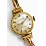 A Sekonda lady's 9ct gold cased wristwatch, circular silvered dial bearing Arabic numerals, on a ros