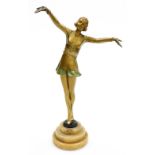 An Art Deco painted spelter figure, modelled as a standing lady in a short dress with her arms outst