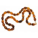 A string of graduated amber beads, with plated lobster claw clasp, forty beads, 114.5g all in.