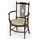 An Edwardian beech and line inlaid carver chair, with an oval seat, raised on turned legs.
