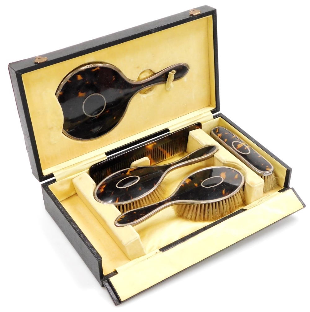 A George V silver and tortoiseshell backed toilet set, comprising pair of hair brushes, clothes brus