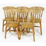 A set of five pale beech kitchen chairs, with solid saddle seats, raised on turned legs united from