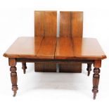 A Victorian walnut wind out dining table, with two additional leaves, raised on turned and fluted le
