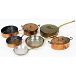 A group of copper saucepans, the largest 32cm diameter, a copper and lead lined two handled pot and