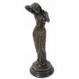 A bronze figure of a semi nude lady, modelled standing, stroking her hair, raised on a socle base, 4