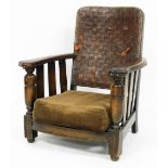 An Ercol oak and leather nursing chair, with a loose cushion seat.