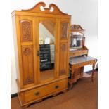 A Victorian satin walnut wardrobe, the break arch pediment above a single mirrored door, inset bevel