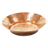 An early 20thC Middle Eastern copper dish, with engraved scrolling and script detailing, 41cm wide.