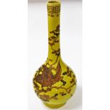 A 19thC Chinese yellow ground bottle vase, decorated in gilt and enamels, with a phoenix perched amo