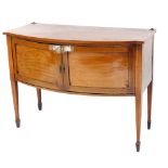 An Edwardian mahogany bow front sideboard, with satin wood cross banding, having a pair of doors ope