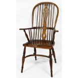 A Victorian ash and elm Windsor chair, with a vase shaped splat, solid saddle seat, raised on turned