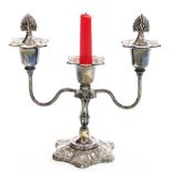 An Elizabeth II silver candelabra, the top with two flame shaped candle snuffers, the body heavily d