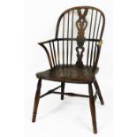 A Victorian ash and elm Windsor chair, with a vase shaped splat, solid saddle seat, raised on turned