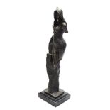 A bronze figure of a semi clad woman, verging on the rocks, raised on a rectangular black marble bas