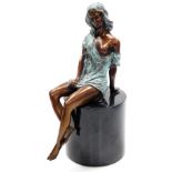 A part patinated bronze figure of a semi nude woman, modelled seated, on oval green marble base, bea