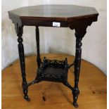 A late 19th/early 20thC occasional table, with carved under tier, heavily varnished, 72cm high, the