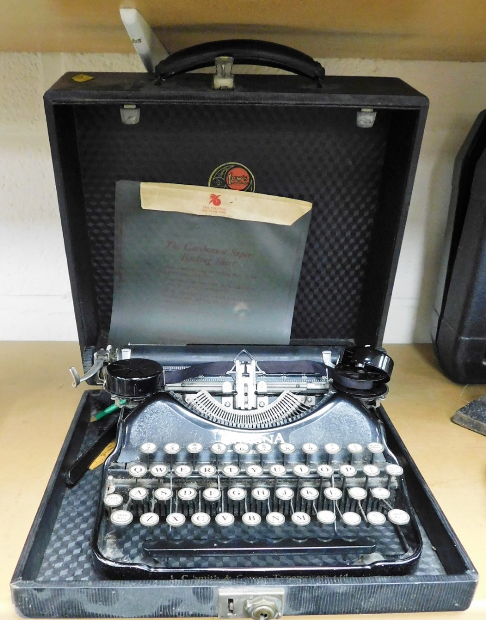 A cased C Smith & Corona typewriter.