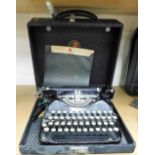 A cased C Smith & Corona typewriter.