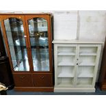 A cream painted two door cabinet, with glazed doors containing four shelves, 117cm high, 96cm wide,