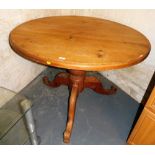A pine circular top dining table, on a turned column raised on four leaf carved cabriole legs, 77cm