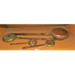 A copper warming pan, with turned wooden handle and various smaller examples.