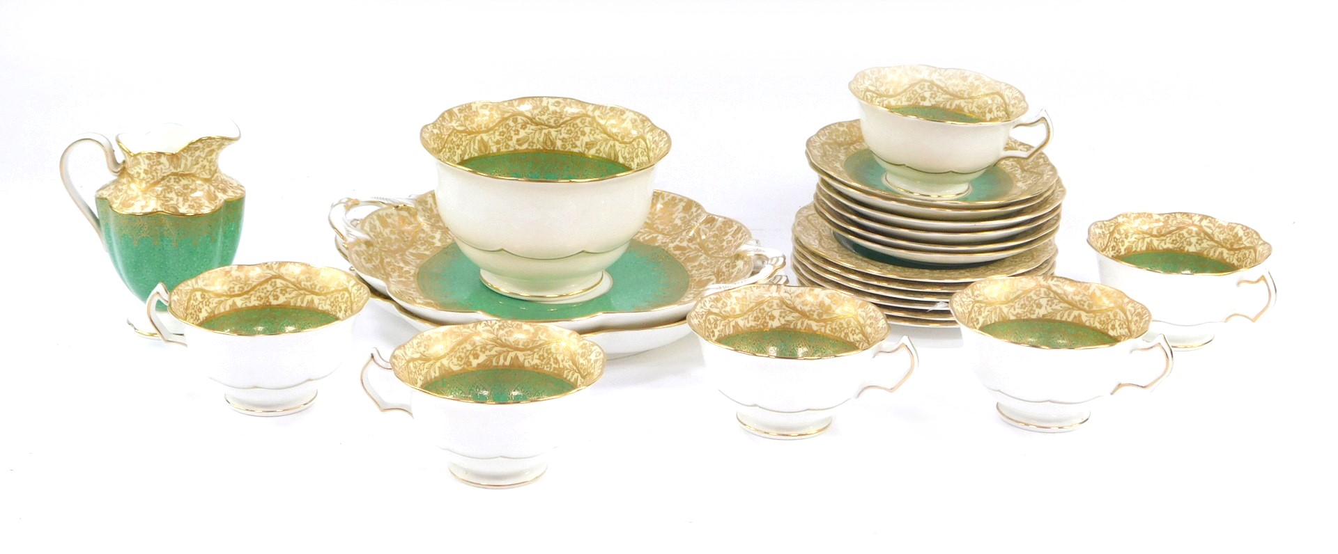 A George Jones and Sons crescent china part tea service, on a green and gilt design with cream