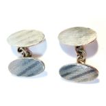 A pair of silver cuff links, each with an oval face, with engine turned striped decoration, 8.5g.