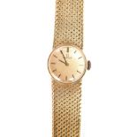 A 9ct gold Omega lady's wristwatch, with gold coloured dial on a bark effect bracelet, 35.2g all in,