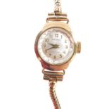 A Seiko 9ct gold ladies wristwatch, the small circular watch head on a silver coloured dial with