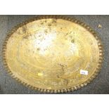 An Eastern hammered brass tray, oval.