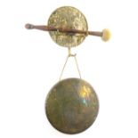 A brass dinner gong, and a lion mask wall hanger, 18cm diameter.