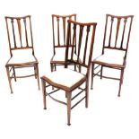 A set of four Edwardian mahogany bedroom chairs, each with boxwood strung borders and a padded seat