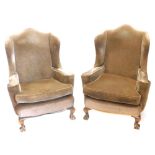 A pair of mahogany wing backed chairs, upholstered in brown fabric on cabriole legs.